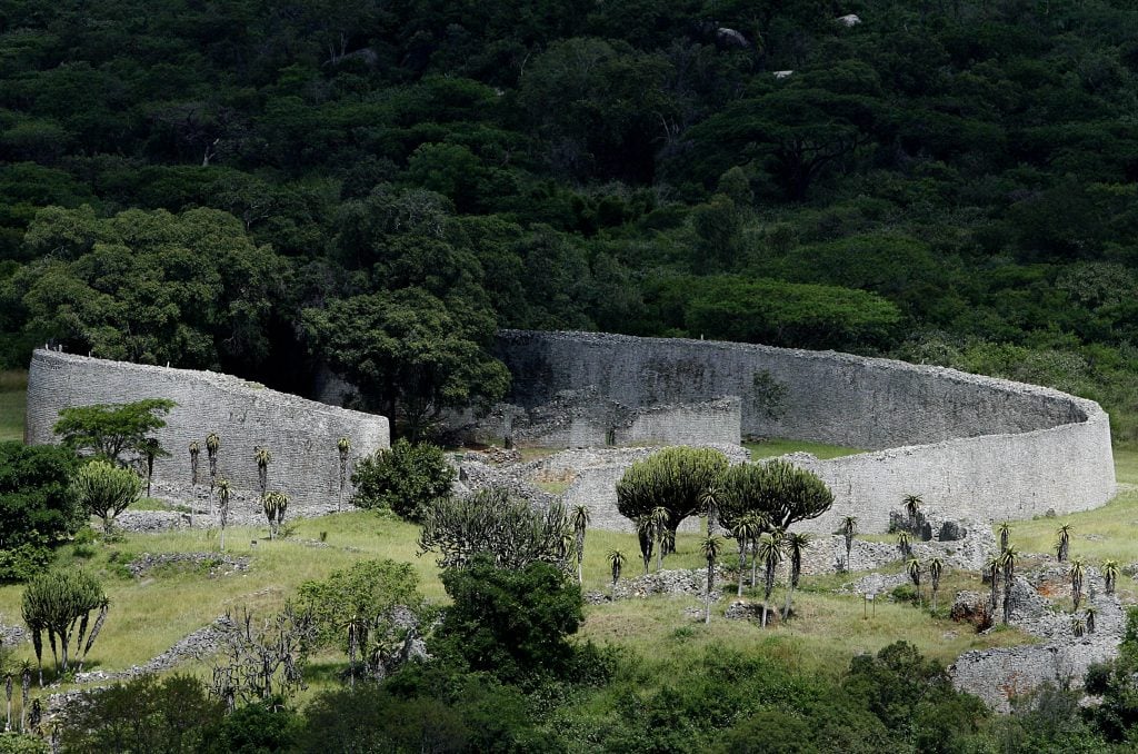 A photograph overlooking the Great Enclosure of the verdant Great Zimbabwe ruins